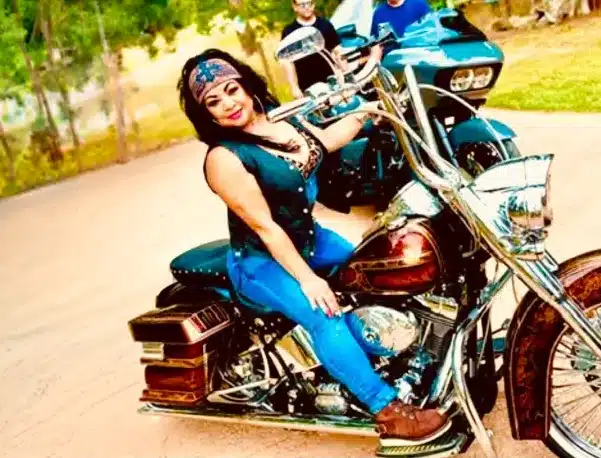 Norma Hernandez posing on her 2004 Harley Davidson Fatboy Softail