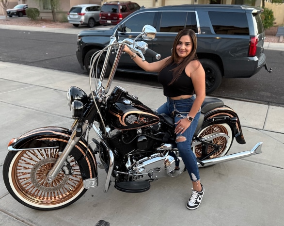 Patricia Escobedo posing on her Harley Davidson Vicla