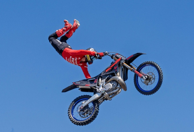 Freestyle Motocross Rider Performing A Superman Seat Grab At The Brigade Fmx Stunt Show